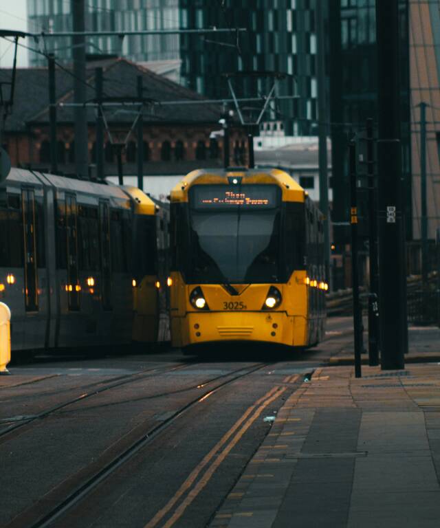 A yellow Metrolink tram in Manchester city centre